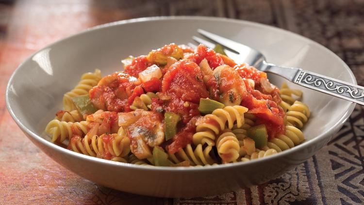 Photo of a bowl with pasta and garden sauce