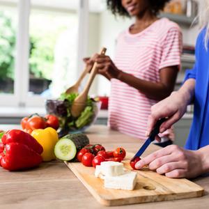 Photo of two women preparing a salad