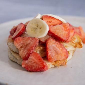 Spoon sauce over pancakes