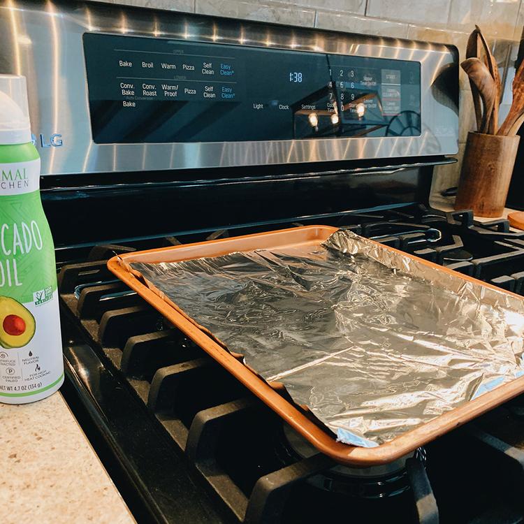 Photo of a baking sheet lined with foil and cooking spray