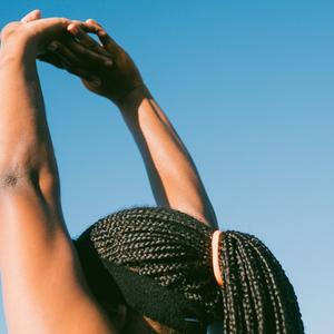 Photo of woman raising her arms to stretch