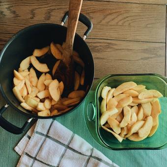 Photo of cooked apples being transferred to a baking dish