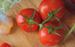 Photo of three tomatoes on a vine