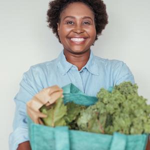 Photo of a woman holding a bag of produce