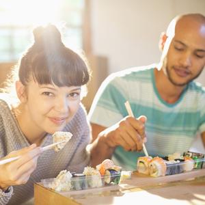 Photo of a girl and a friend eating sushi