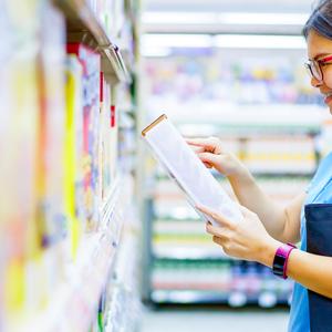 Photo of a girl reading the label on a box of cereal