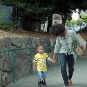 Woman and child walking with bagged groceries