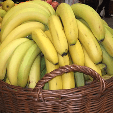 Photo of several bunches of ripe bananas in a basket