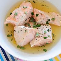 Photo of cooked salmon in a broth, in a bowl