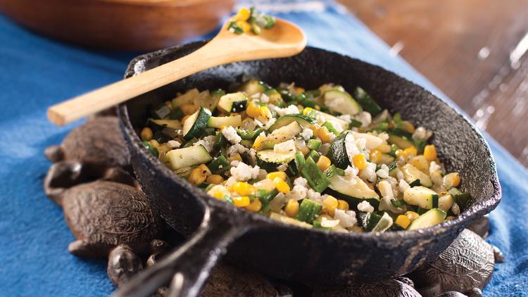 Photo of corn and squash saute in a frying pan