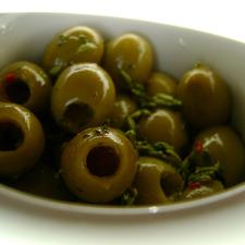 Photo of pitted green olives in a bowl