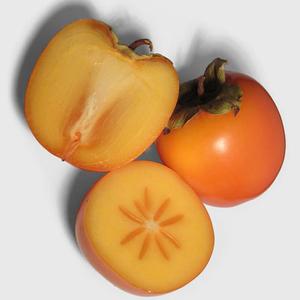 Photo of one whole persimmon and another one cut in half
