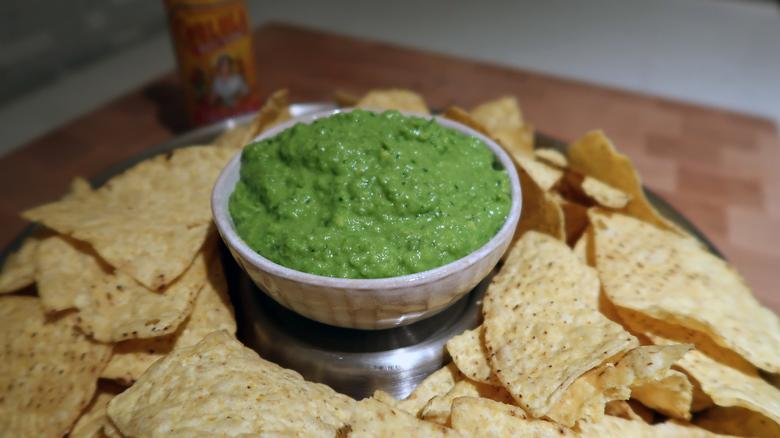 Photo of prepared green pea guacamole with tortilla chips