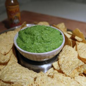 Photo of prepared green pea guacamole with tortilla chips