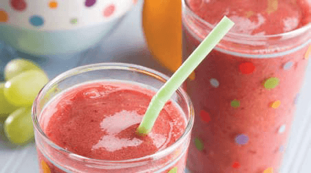 Photo of a great grape smoothie in a glass with a straw