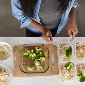 Photo of a woman prepping several meals at once