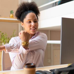 Photo of a woman stretching at her desk