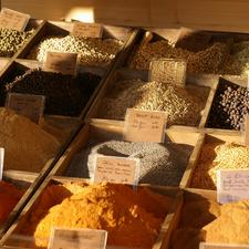 Photo of many types of spices in wooden boxes