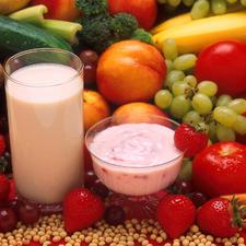 Photo of a bowl of yogurt, a glass of milk, and many types of fresh fruit and vegetables