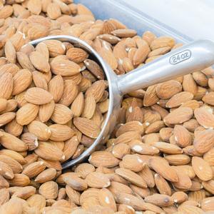 Photo showing bulk bin with almonds and scoop