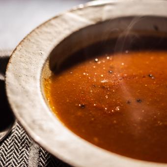 Photo of a bowl of steaming hot Tomato and White Bean Soup