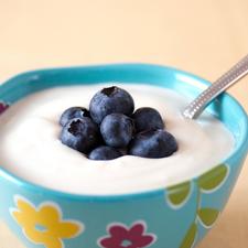 Photo of a bowl of yogurt with fresh blueberries