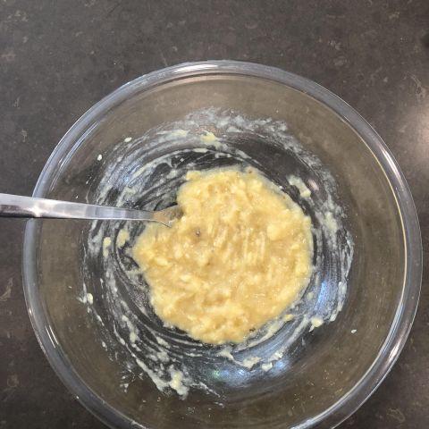 Mash bananas in a bowl with fork